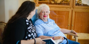 Caregiver reading to senior client