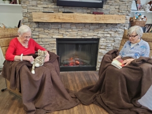 Two women in front of fireplace